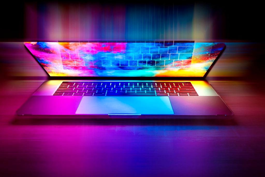 Office desk with laptop and contact icons on screen